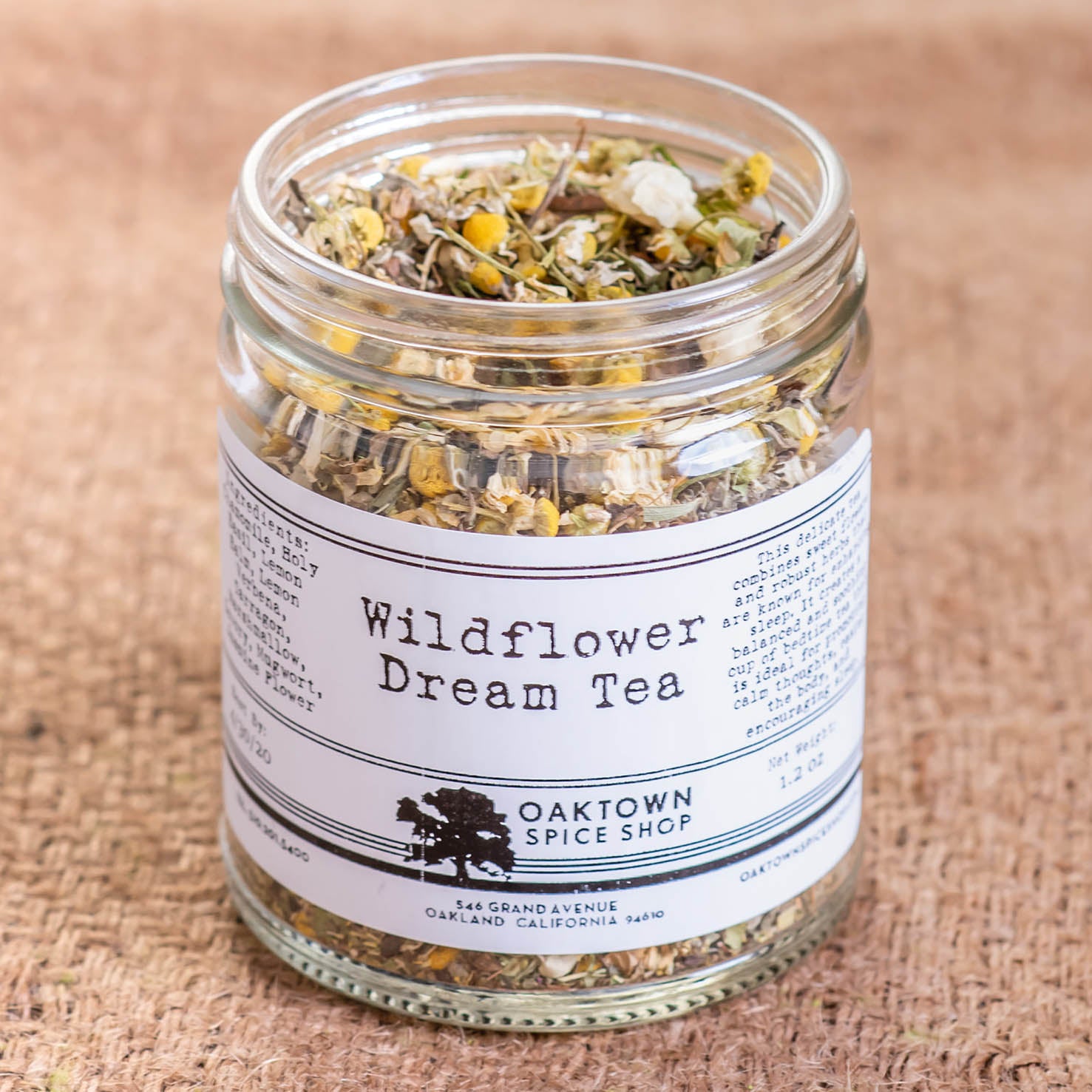 A glass jar filled with Wildflower Dream Tea. Our Wildflower Dream Tea tea combines sweet flowers and robust herbs that are known for enhancing sleep. It creates a balanced and soothing cup of bedtime tea that is ideal for promoting calm thoughts, easing the body, and encouraging sleep. Ingredients are Chamomile, Holy Basil, Lemon Balm, Lemon Verbena, Tarragon, Marshmallow, Savory, Mugwort and Jasmine Flower.
